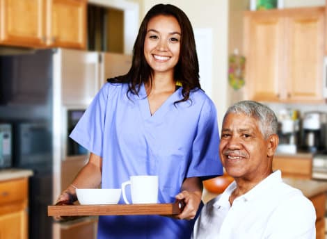 senior man and caregiver smiling