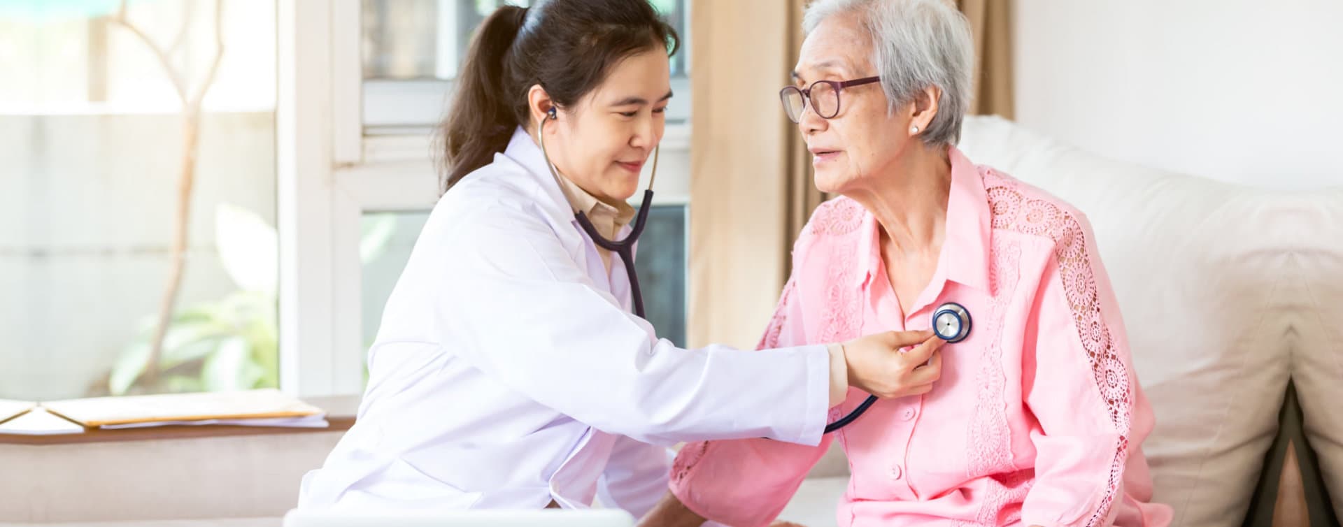 senior woman checked by a caregiver