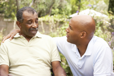 senior man and caregiver smiling