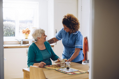 caregiver serving senior woman