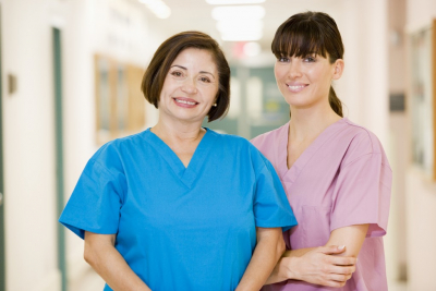 two caregivers smiling