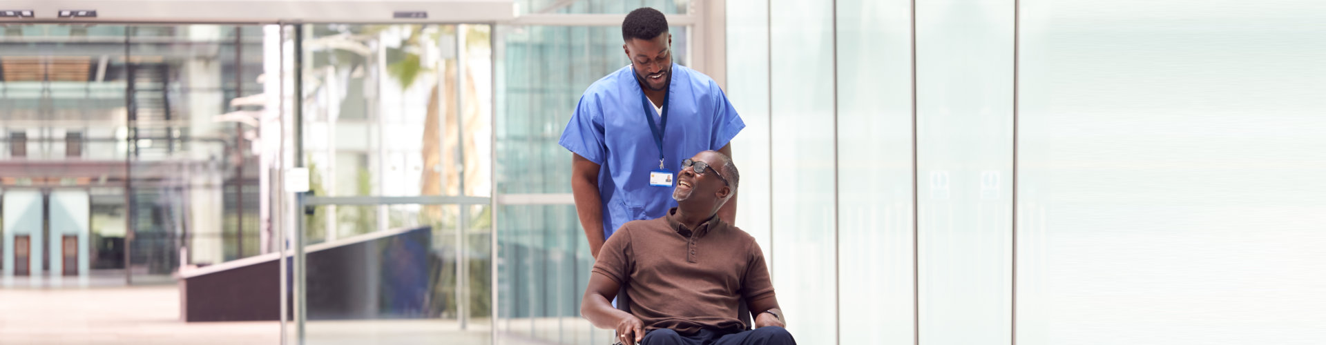 senior man and caregiver smiling