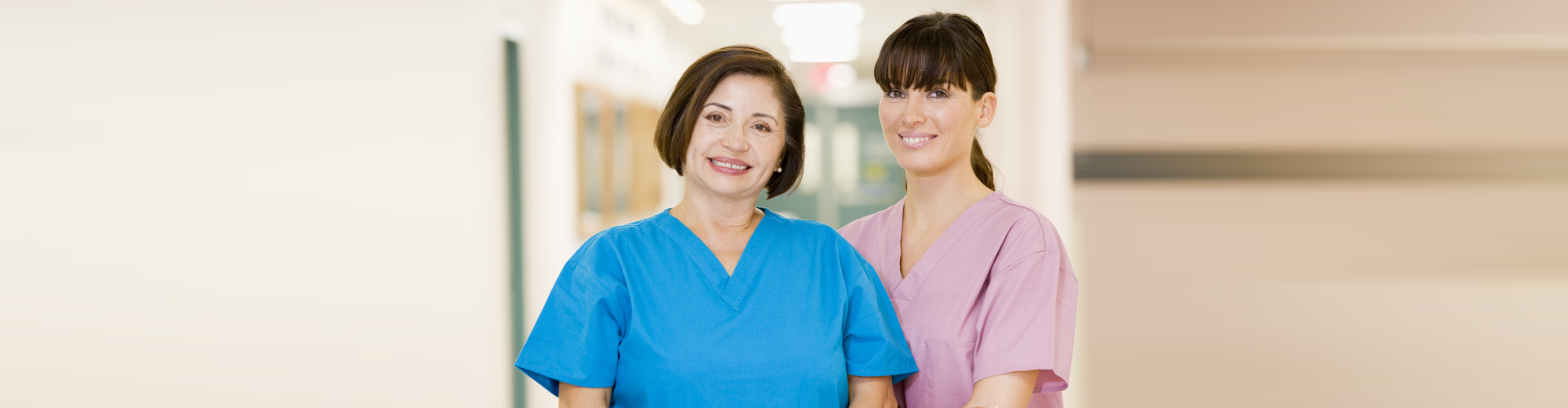 two caregivers smiling